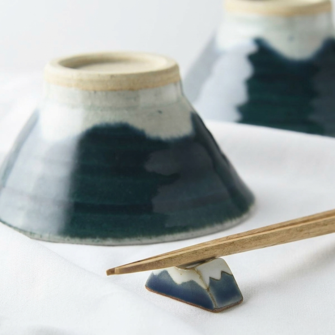 Ceramic holder with blue glaze and wooden base on a white surface