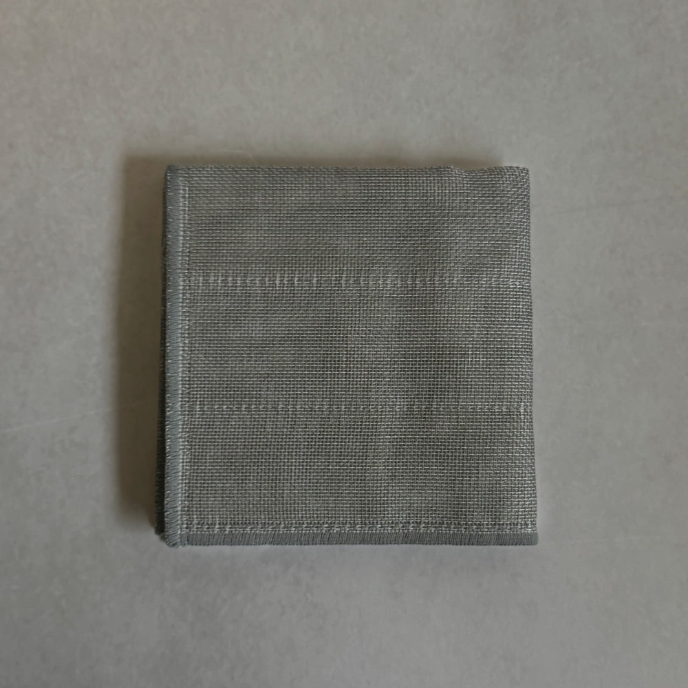 Folded Japanese grey kitchen cloth on a light grey background