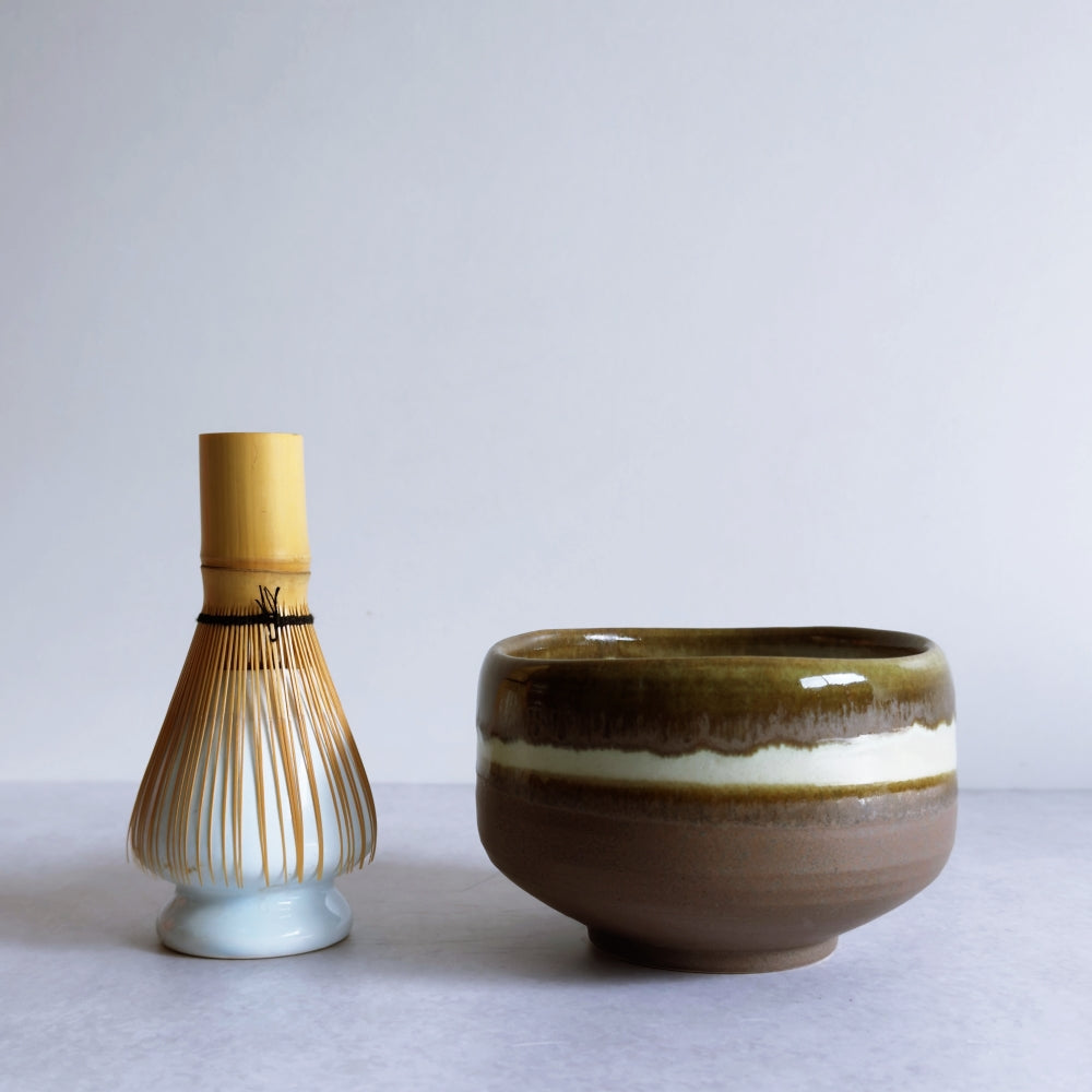 Ceramic matcha whisk holder and bowl on a light gray background