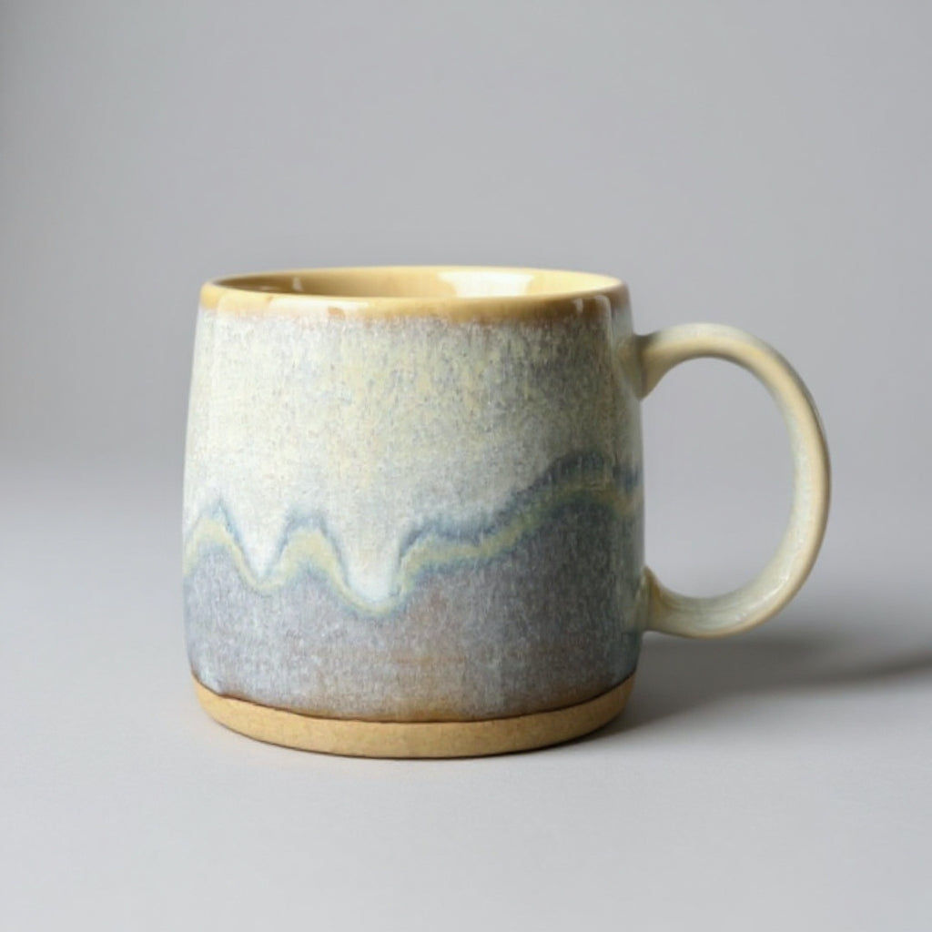 Ceramic mug with wavy pattern on a gray background