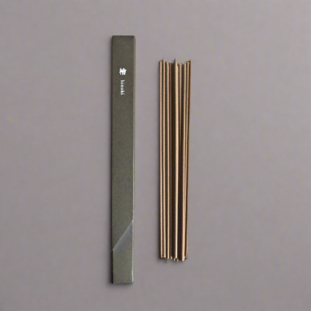 Top-down view of Kousaido Waboku Hinoki incense sticks next to minimalist box packaging.