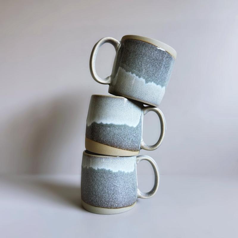 Stack of three grey TOKA Japanese porcelain mugs with large loop handles, artisanal Mino ware from Gifu.