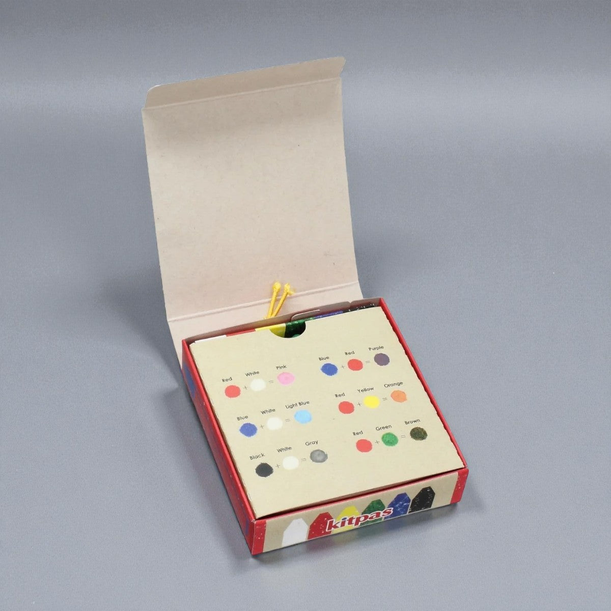 Open box of Kitpas with color swatches on a gray background