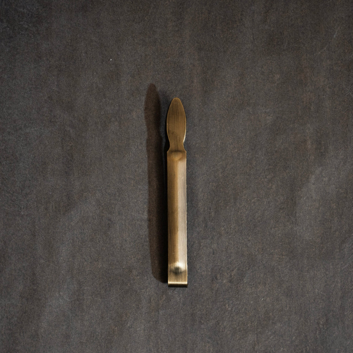 Wick trimmer on a dark grey background