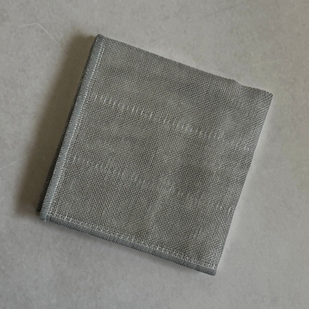 Folded Japanese grey kitchen cloth on a light grey background