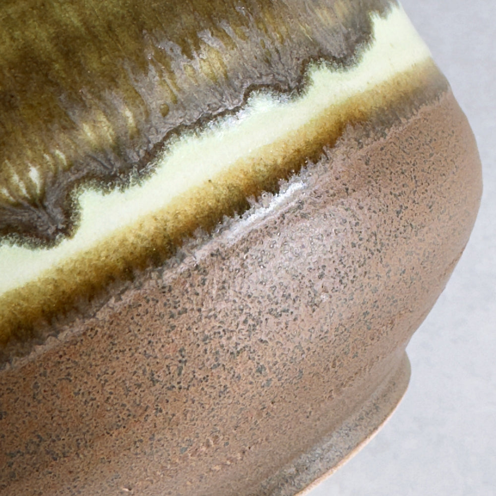 Close-up of a Japanese ceramic bowl with a textured surface on a white background